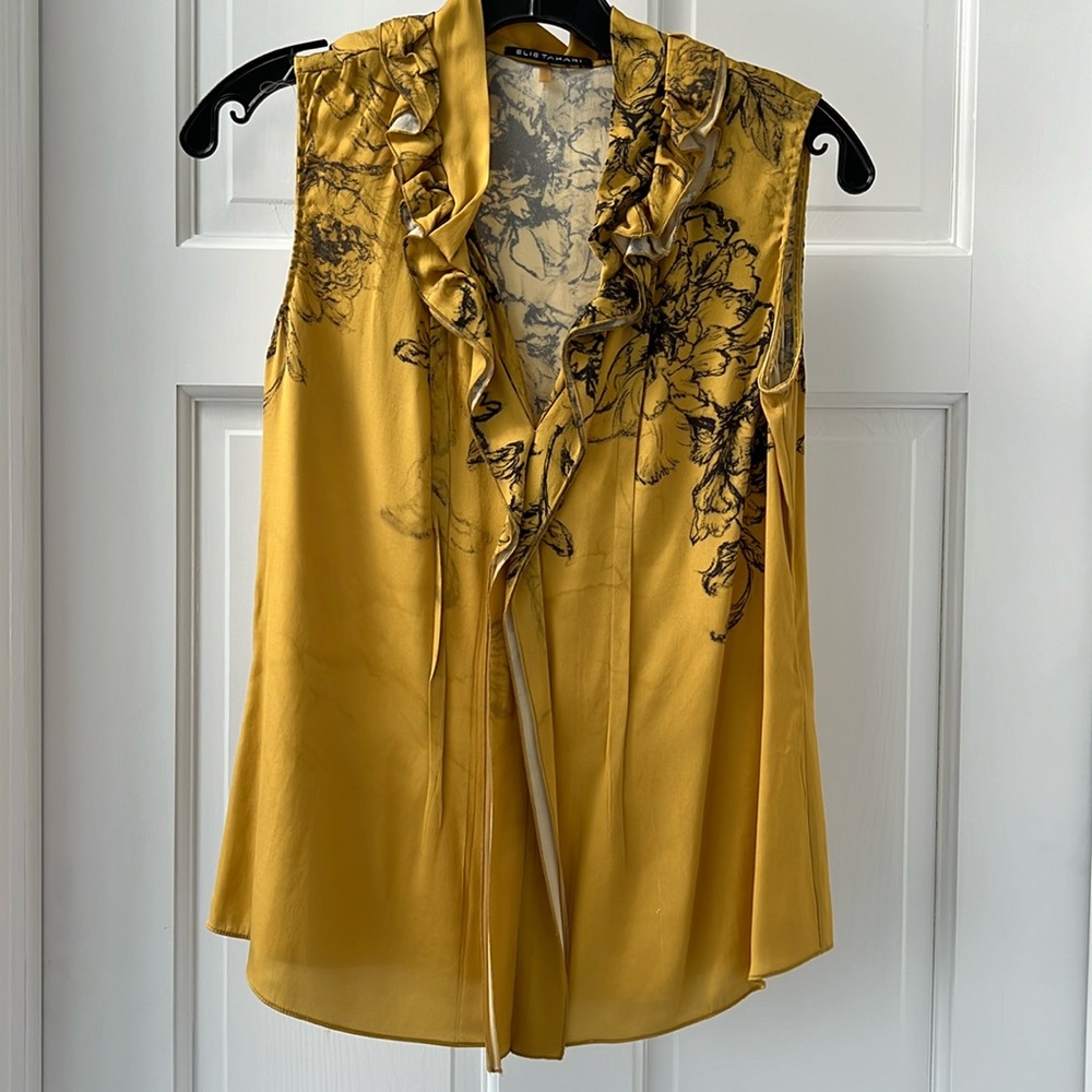 Silk sleeveless blouse with ruffle neck collar